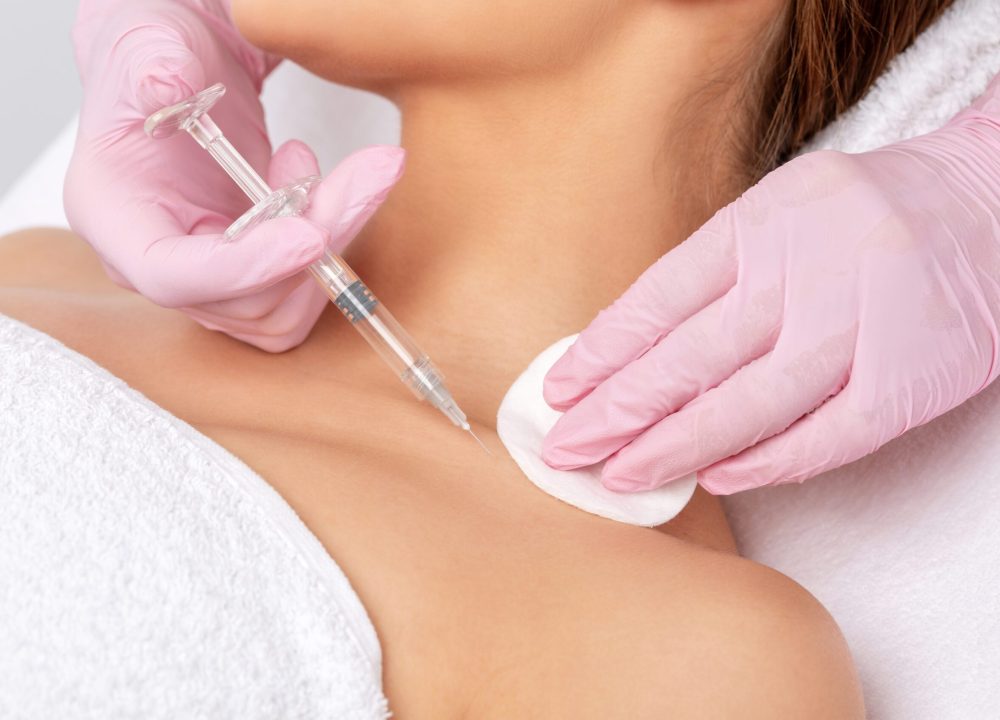 Cosmetologist makes rejuvenating anti wrinkle injections on the neck